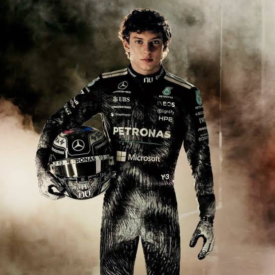 Kimi Antonelli in his Mercedes race suit, holding his helmet