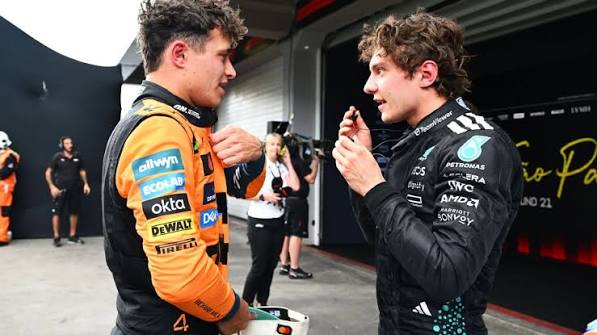 Lando and Kimi talking in the paddock
