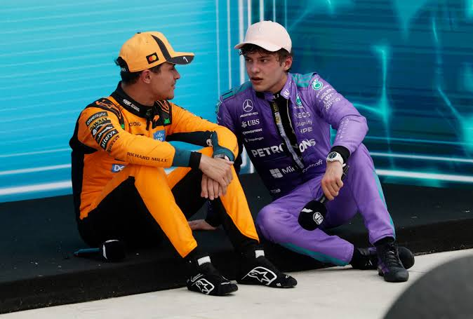 Lando and Kimi sitting side by side, deep in conversation